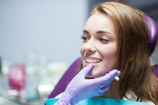 A woman receiving cosmetic dentistry treatment near The Bluffs in Jupiter