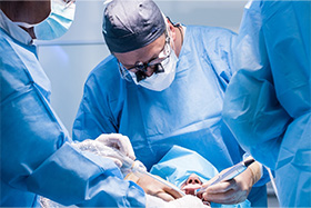 Dentist and assistants performing dental implant surgery on a patient
