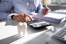 patient calculating cost of dentures in Juno Beach
