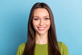 Woman smiling after successful dental implant salvage treatment