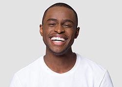 man smiling after having tooth-colored fillings