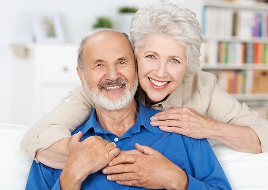 Older couple smiling at home