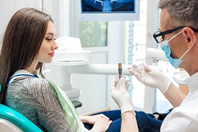 patient talking to dentist about dental implants