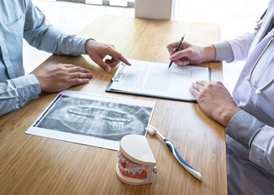 Doctor and patient discussing cost of dental implants