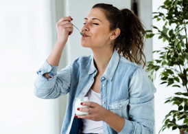 Woman enjoying a serving of yogurt