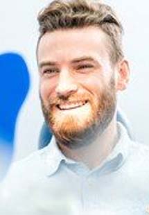 Bearded man looking at his smile in a mirror