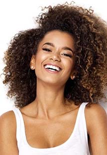 Young smiling woman wearing a white tank top