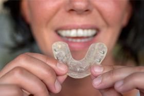 Woman holding custom mouthguard