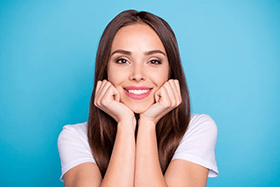 a woman smiling after undergoing a smile makeover