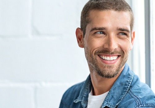 Handsome, smiling man enjoying benefits of metal-free restorations