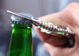 Closeup of patient using bottle opener to prevent chipped tooth in Juno Beach