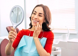 happy dental patient with mirror