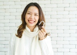 woman holding Invisalign