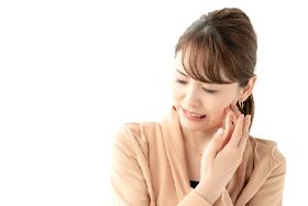 Woman with facial pain, experiencing symptoms of TMJ disorder