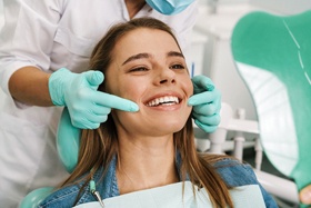 Patient smiling during appointment for occlusal adjustment