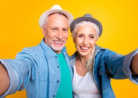 Smiling senior couple with nice teeth taking selfie