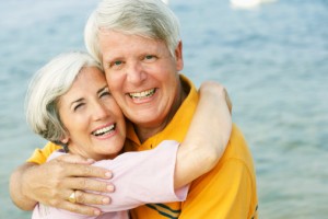 couple with dental crowns smiling