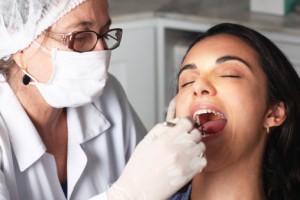 Woman relaxes as she receives the dental crowns north palm beach residents trust