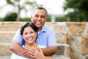 An older couple hugging and smiling.