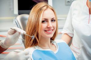 a young woman sitting in the dentist chair