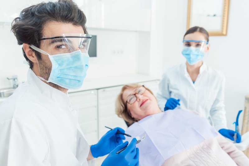 Dentist near Jupiter wearing PPE with patient