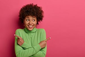 woman smiling and choosing veneers or crowns