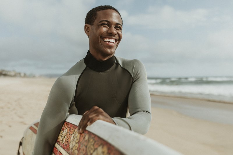 man smiling while on the beach