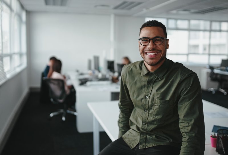 young man smiling at work