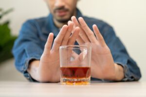 Person refusing a glass of alcohol